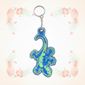 Gecko outlined keychain on a pale tropical background