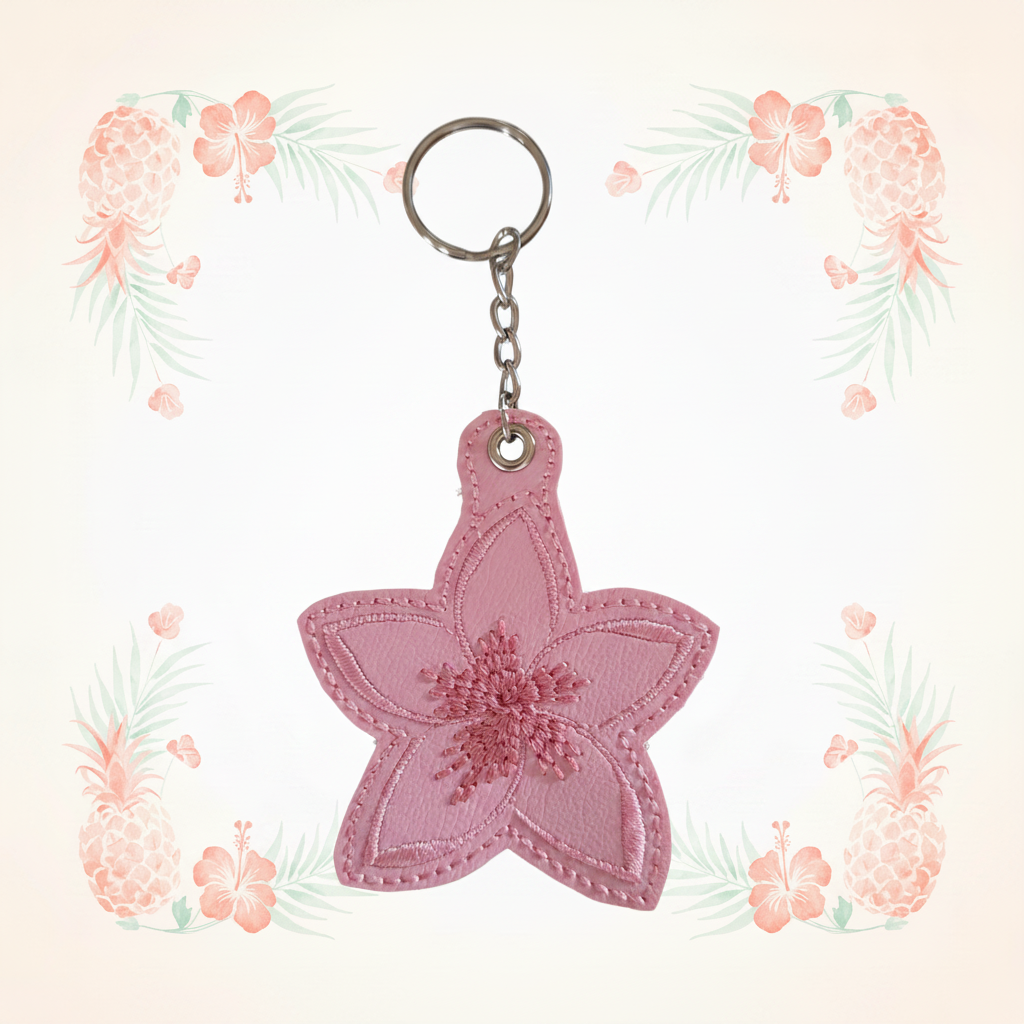 Pink plumeria keychain with full chain on a pale tropical background without a shadow
