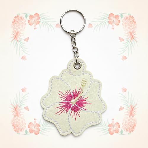 Cream and pink hibiscus keychain on a pale tropical background without a shadow