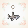 Shark embroidered keychain on a pale tropical background without a shadow